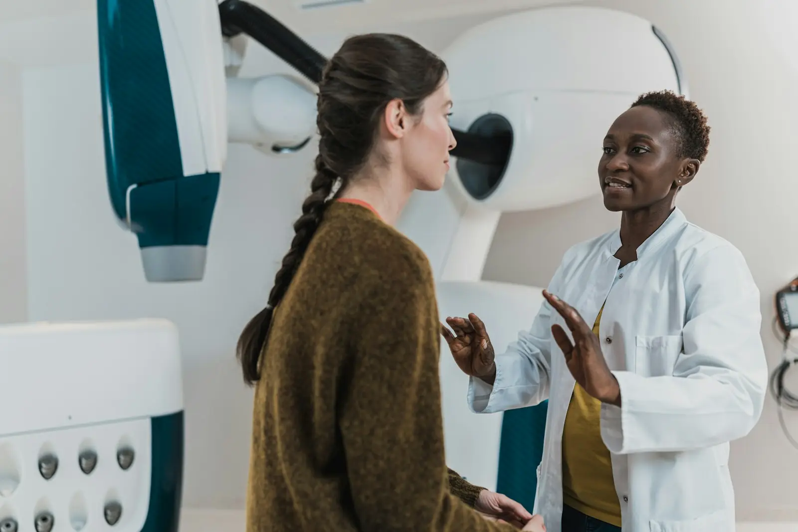A clinician talking with a patient in a modern clinic