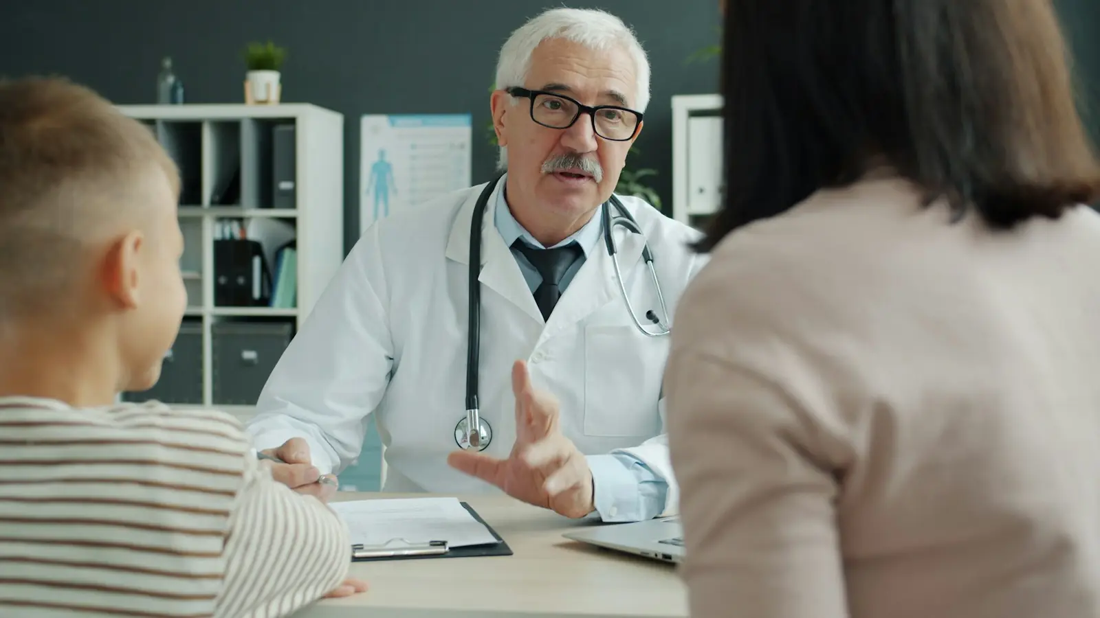 A primary care doctor with a parent and child
